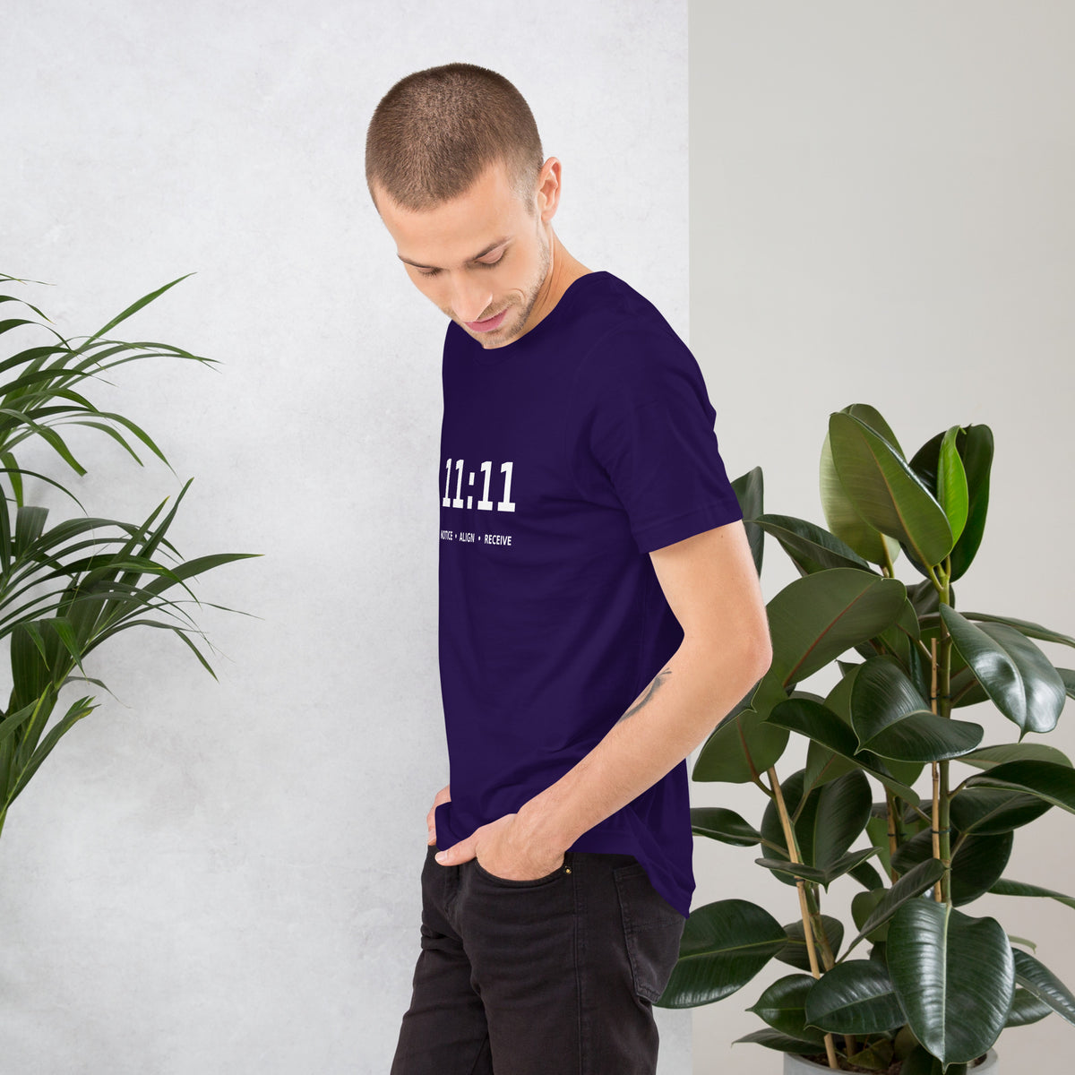 11:11 angel number design, the number set in plain white type above Notice, Align, Receive, on a team purple unisex t-shirt, left side view