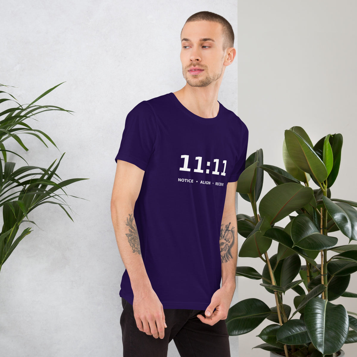 11:11 angel number design, the number set in plain white type above Notice, Align, Receive, on a team purple unisex t-shirt, right side view