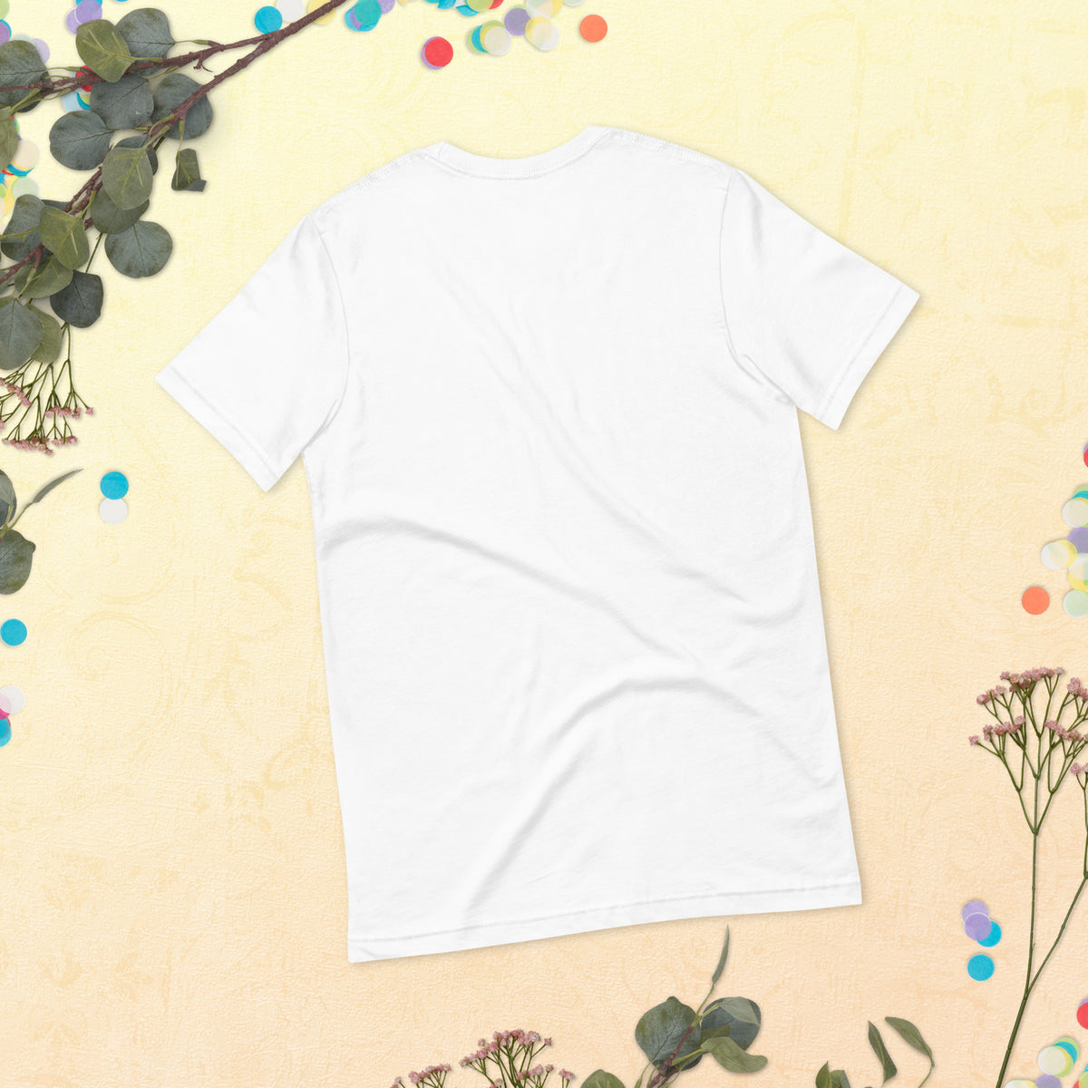 Love Gave You Wings design, on a white unisex t-shirt, plain back view with no design, styled flat lay on a cream backdrop