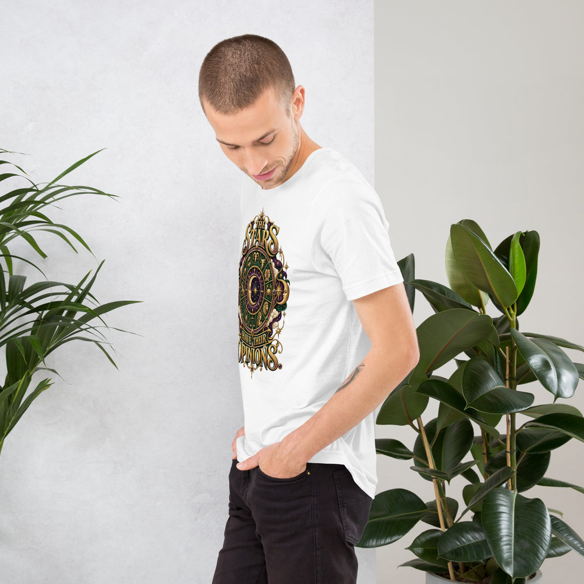 The Stars Have Their Opinions astrology design, a green and purple zodiac wheel of pictorial star signs with a crescent moon and sun face at its center, framed by clouds and gold lettering, on a white unisex t-shirt, left view