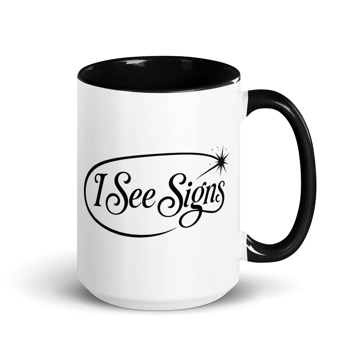 I See Signs design, the words set in black script inside a thin oval with a four-pointed star, on a white ceramic mug with a black interior, 15 oz, right side view