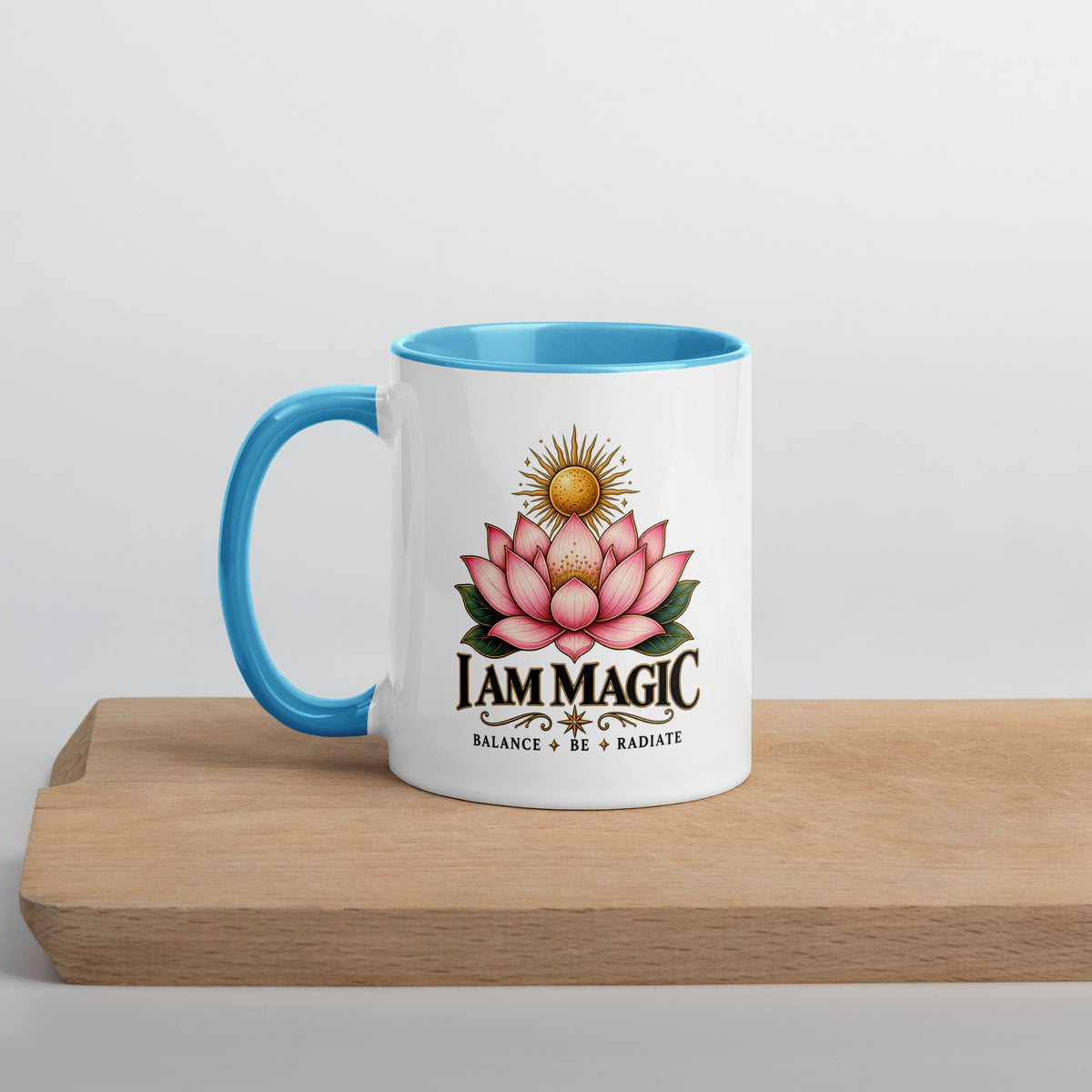 I Am Magic design with a gold lotus, Be Magical collection, on a white ceramic mug with a blue interior, 11 oz, left side view