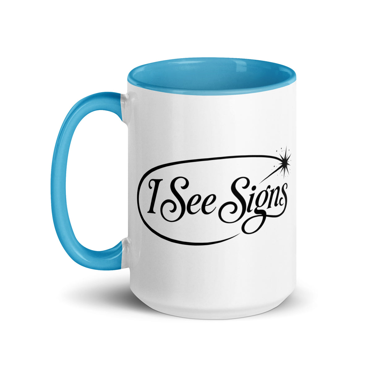 I See Signs design, the words set in black script inside a thin oval with a four-pointed star, on a white ceramic mug with a blue interior, 15 oz, left side view