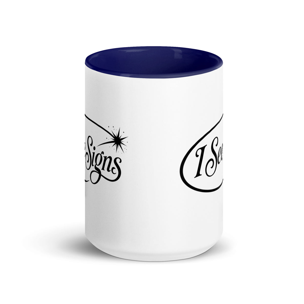 I See Signs design, the words set in black script inside a thin oval with a four-pointed star, on a white ceramic mug with a dark blue interior, 15 oz, front view