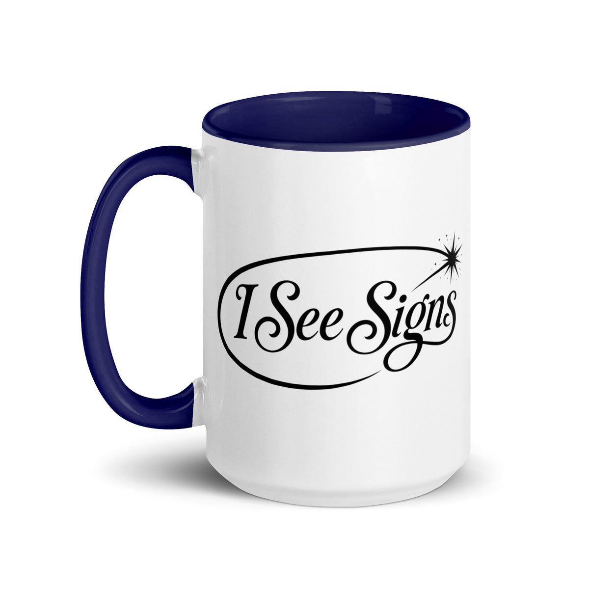 I See Signs design, the words set in black script inside a thin oval with a four-pointed star, on a white ceramic mug with a dark blue interior, 15 oz, left side view