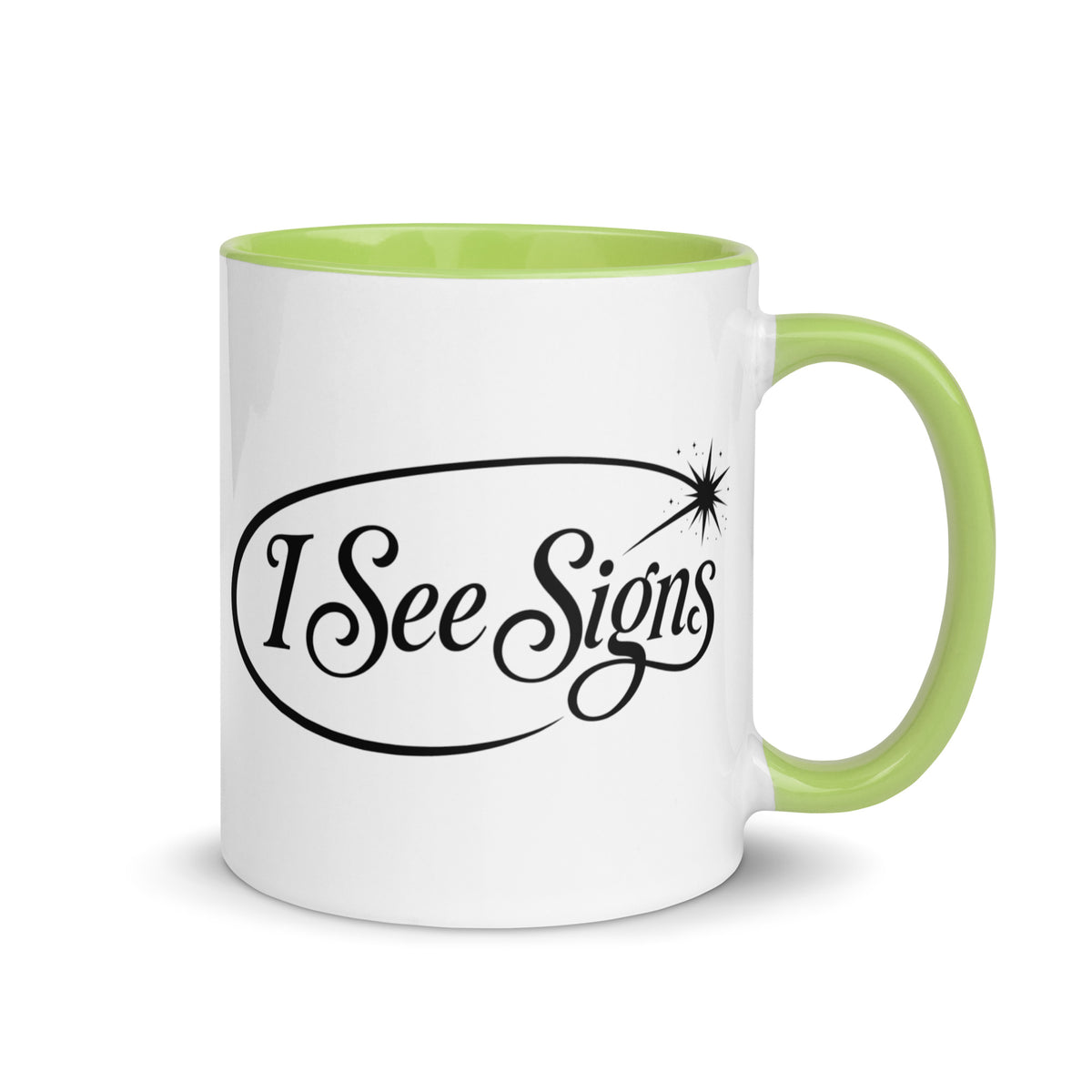 I See Signs design, the words set in black script inside a thin oval with a four-pointed star, on a white ceramic mug with a green interior, 11 oz, right side view