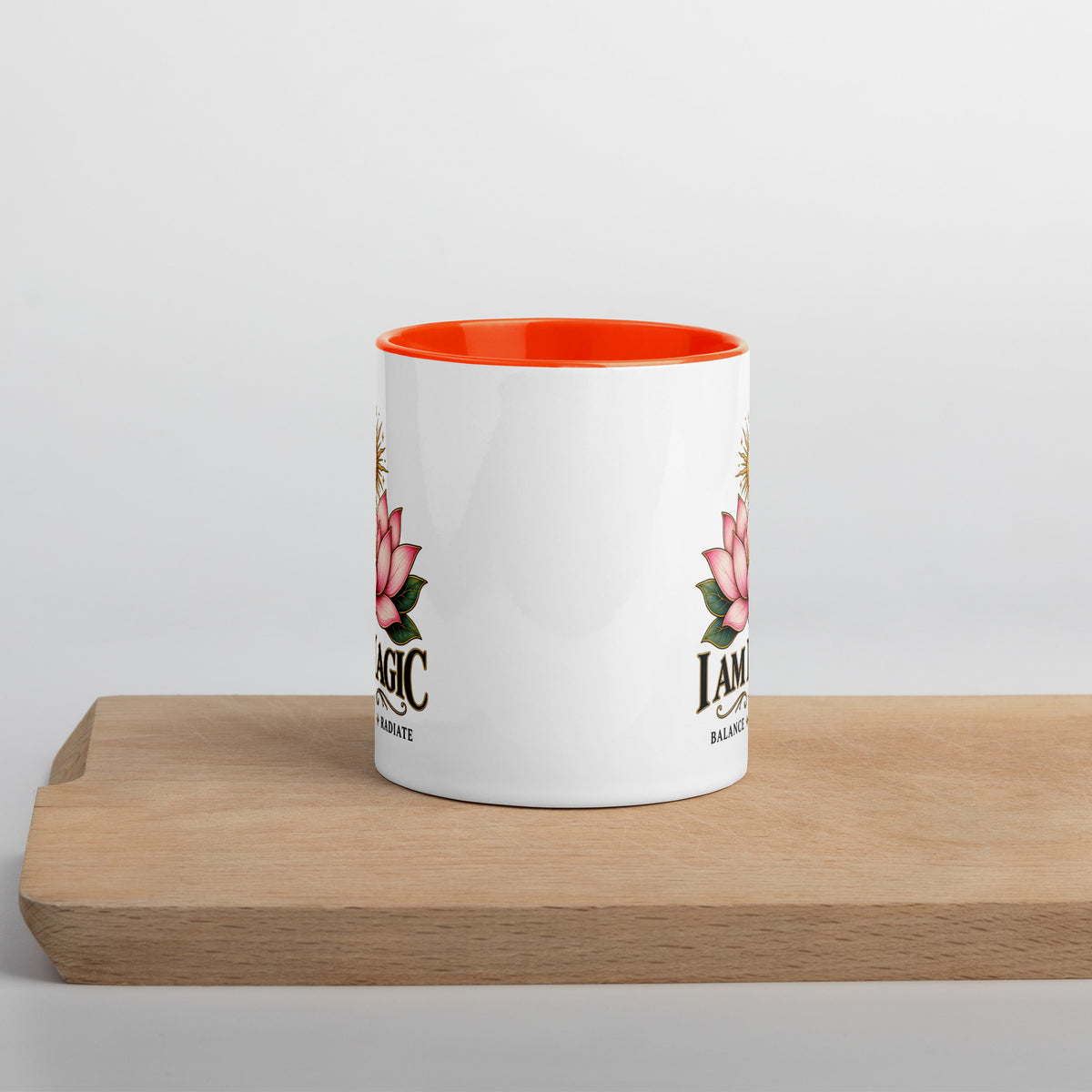 I Am Magic design with a gold lotus, Be Magical collection, on a white ceramic mug with an orange interior, 11 oz, front view