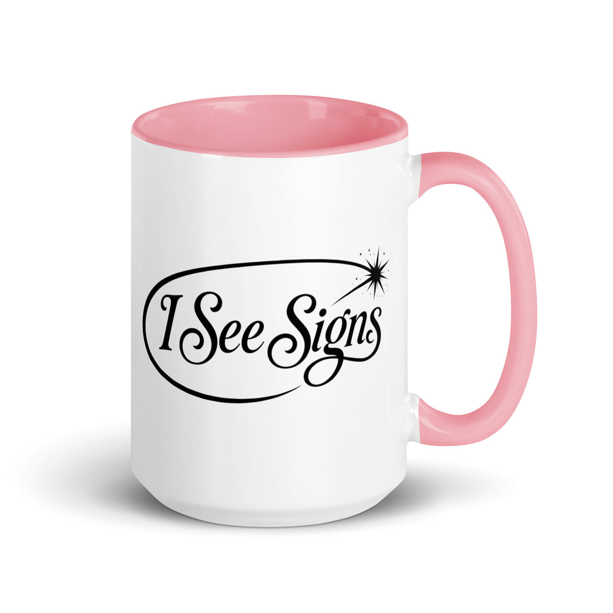 I See Signs design, the words set in black script inside a thin oval with a four-pointed star, on a white ceramic mug with a pink interior, 15 oz, right side view