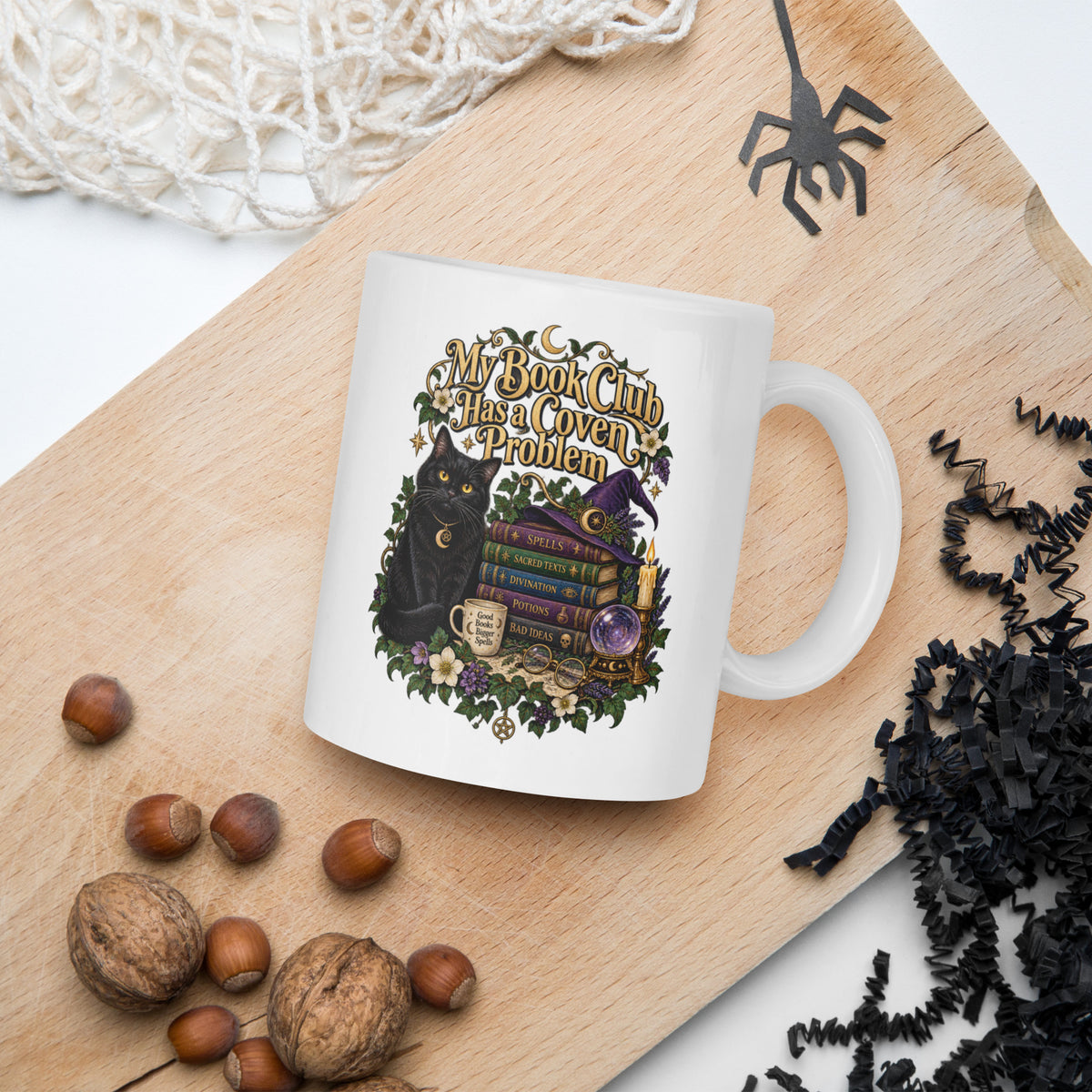 My Book Club Has A Coven Problem dark academia design, a witchy black cat, a crystal ball and a stack of spellbooks, on a white glossy mug, 11 oz, in a Halloween scene