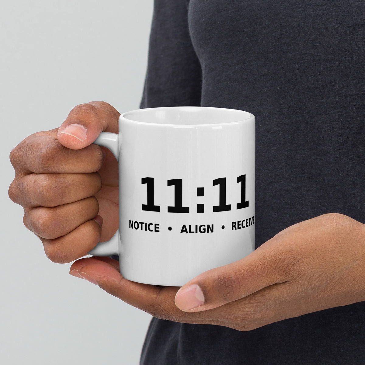 11:11 angel number design, the number set in plain white type above Notice, Align, Receive, on a white glossy mug, 11 oz, handle on the left