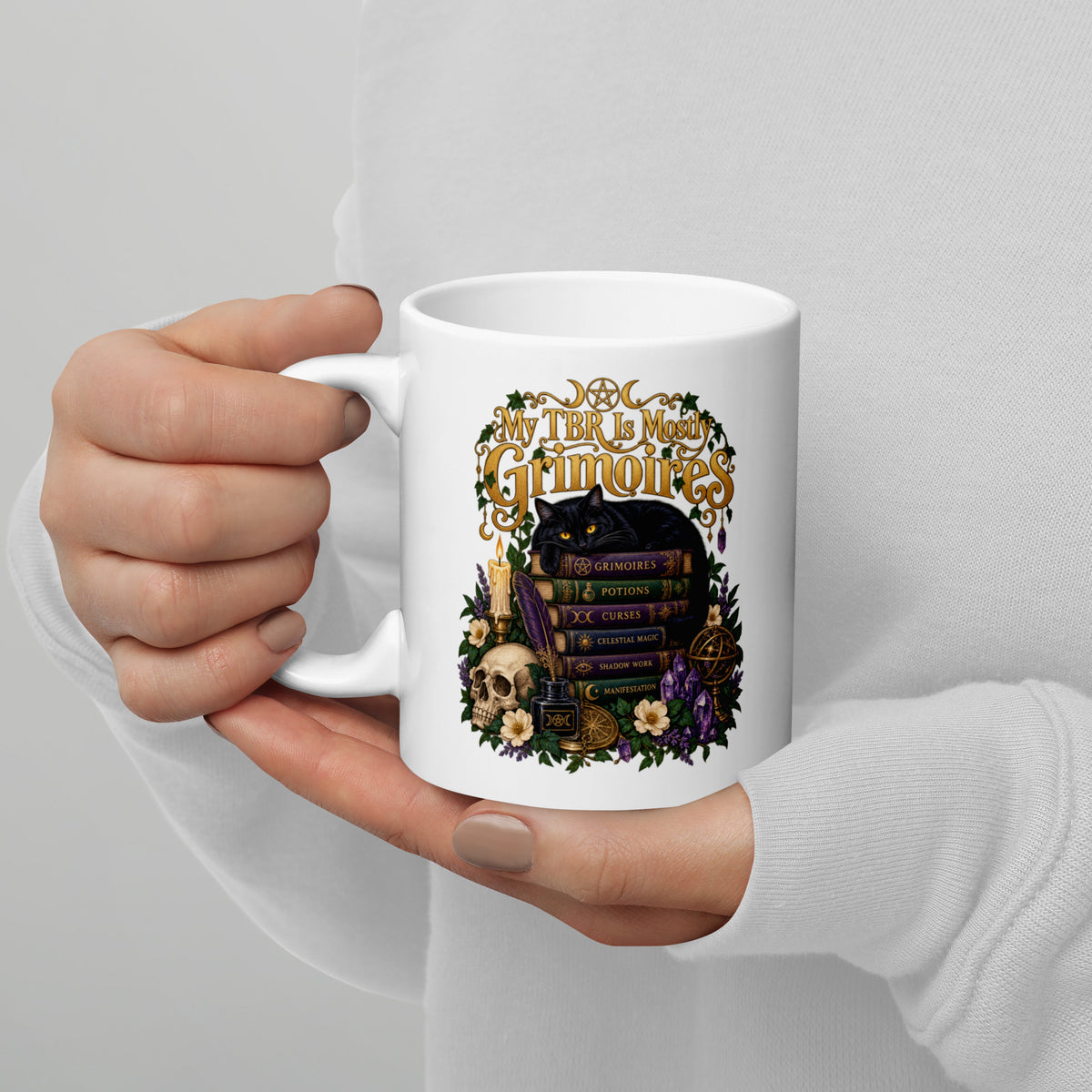My TBR Is Mostly Grimoires dark academia design, a black cat guarding a stack of grimoires beside a skull, on a white glossy mug, 11 oz, handle on the left