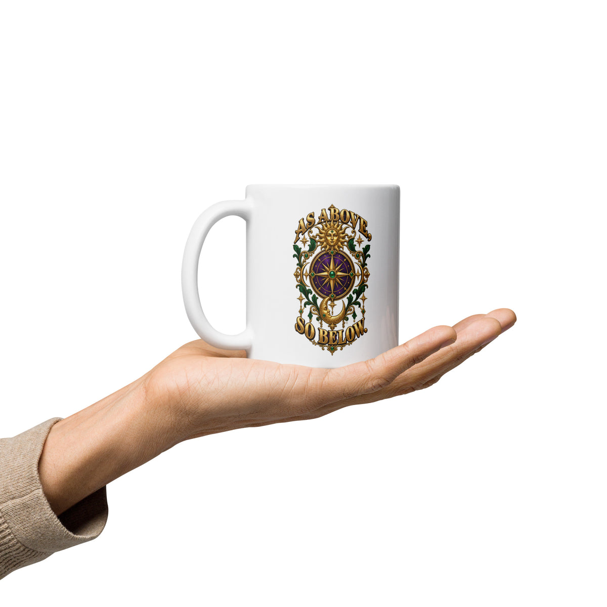As Above, So Below astrology design, a gold sun face above a purple and gold compass rose with a crescent moon below, framed by emerald foliage, on a 11 oz white glossy mug, handle on the left