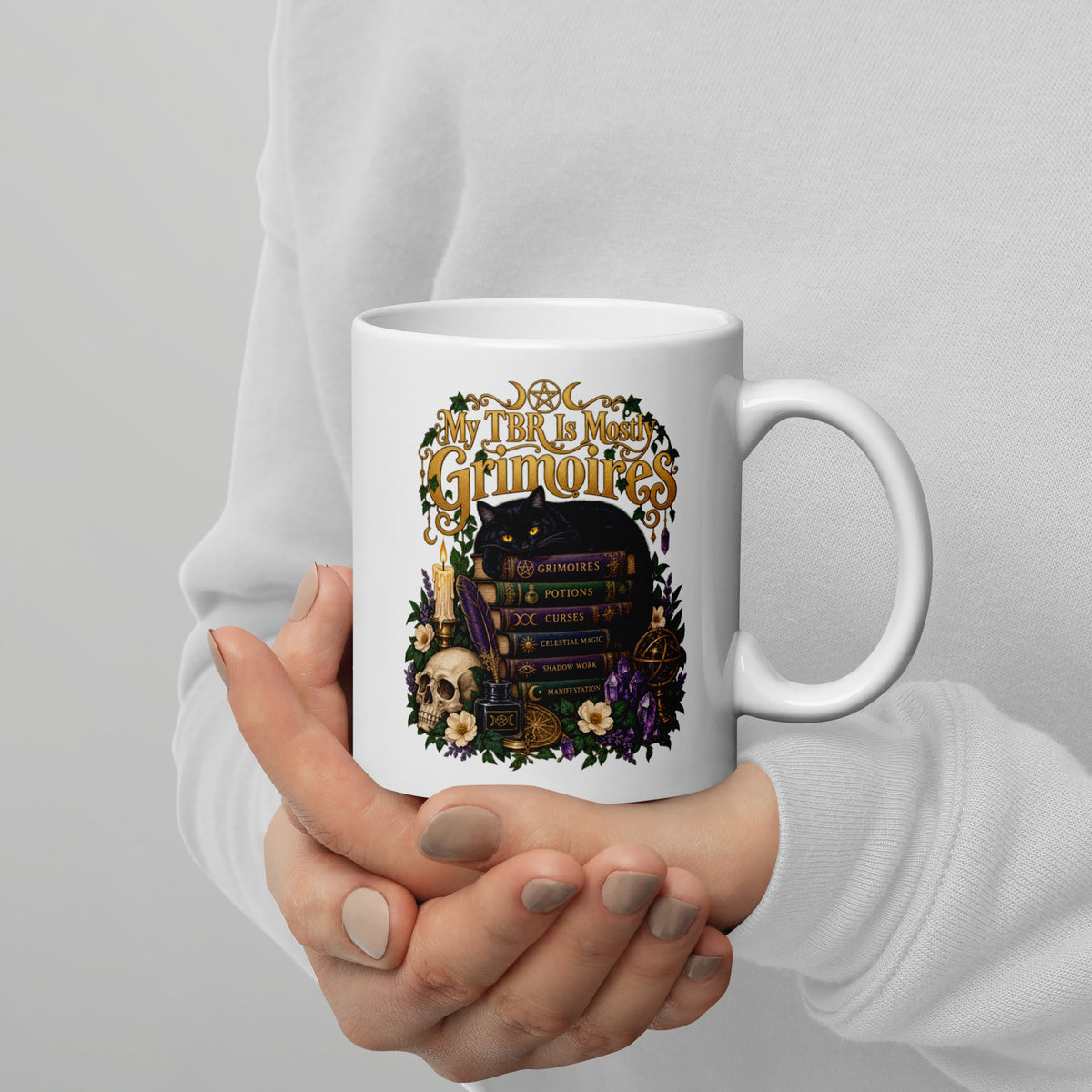 My TBR Is Mostly Grimoires dark academia design, a black cat guarding a stack of grimoires beside a skull, on a white glossy mug, 11 oz, handle on the right