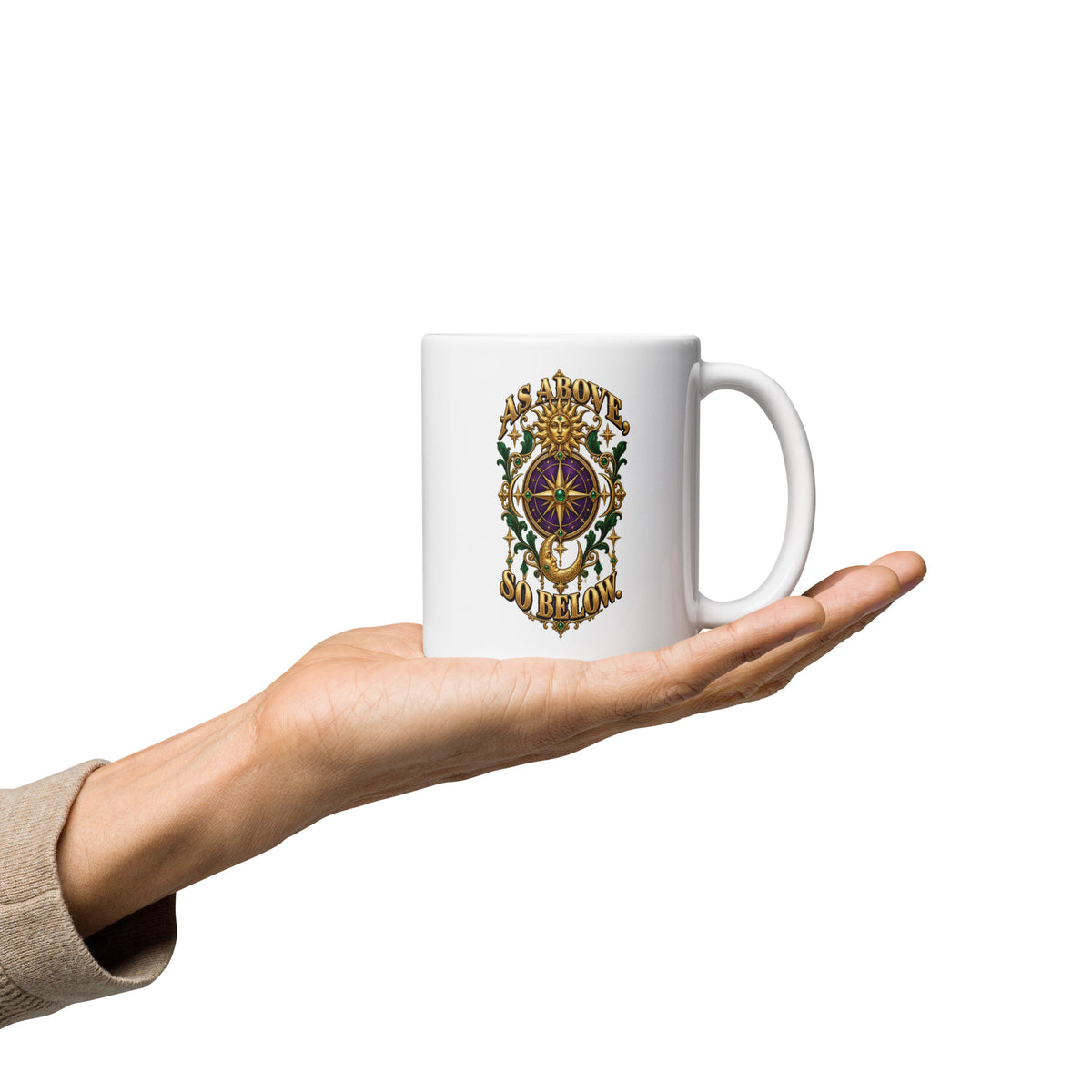 As Above, So Below astrology design, a gold sun face above a purple and gold compass rose with a crescent moon below, framed by emerald foliage, on a 11 oz white glossy mug, handle on the right