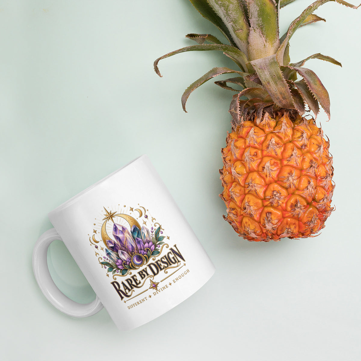Rare by Design Crystals design, an amethyst cluster, on a white glossy mug, 11 oz, styled with pineapple