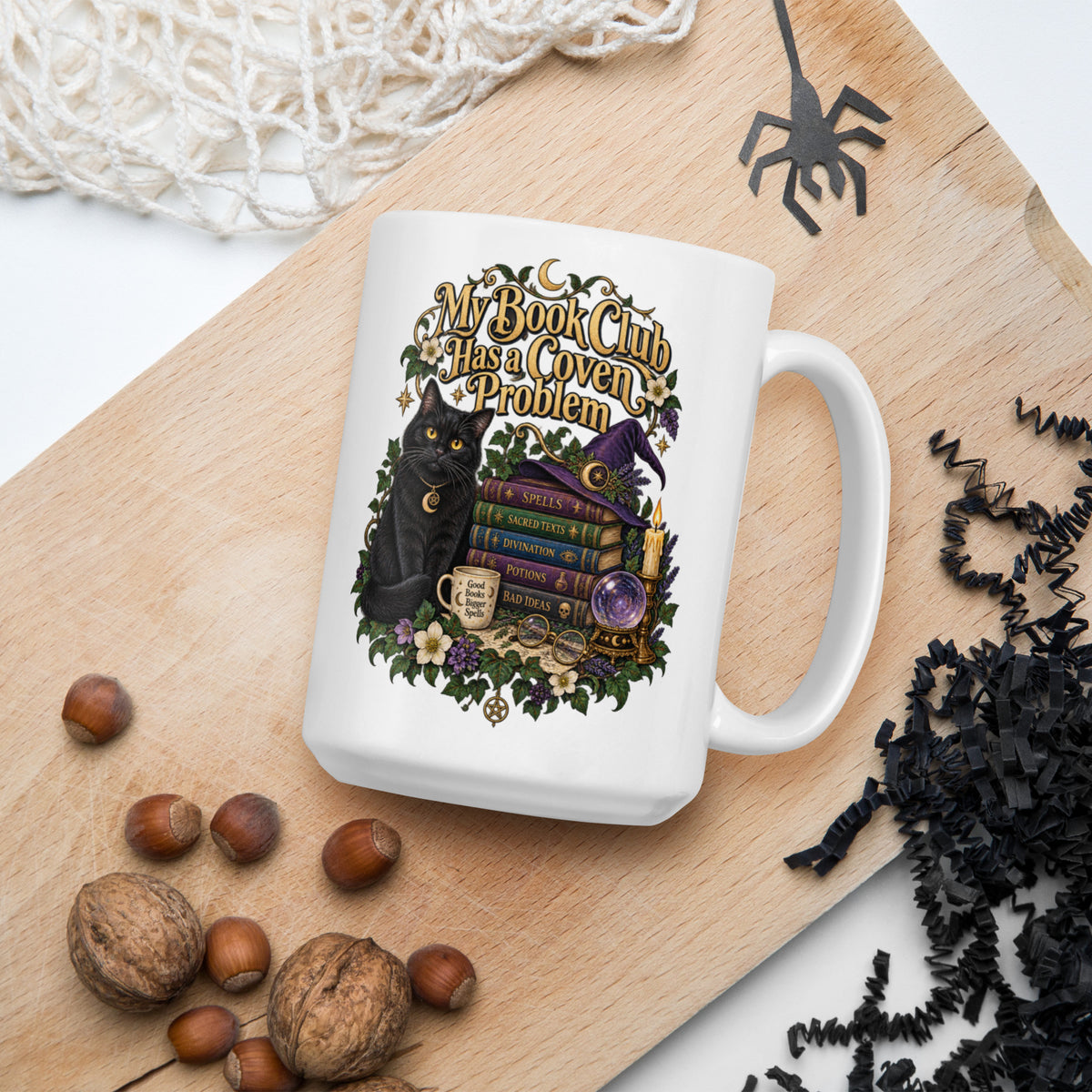 My Book Club Has A Coven Problem dark academia design, a witchy black cat, a crystal ball and a stack of spellbooks, on a white glossy mug, 15 oz, in a Halloween scene