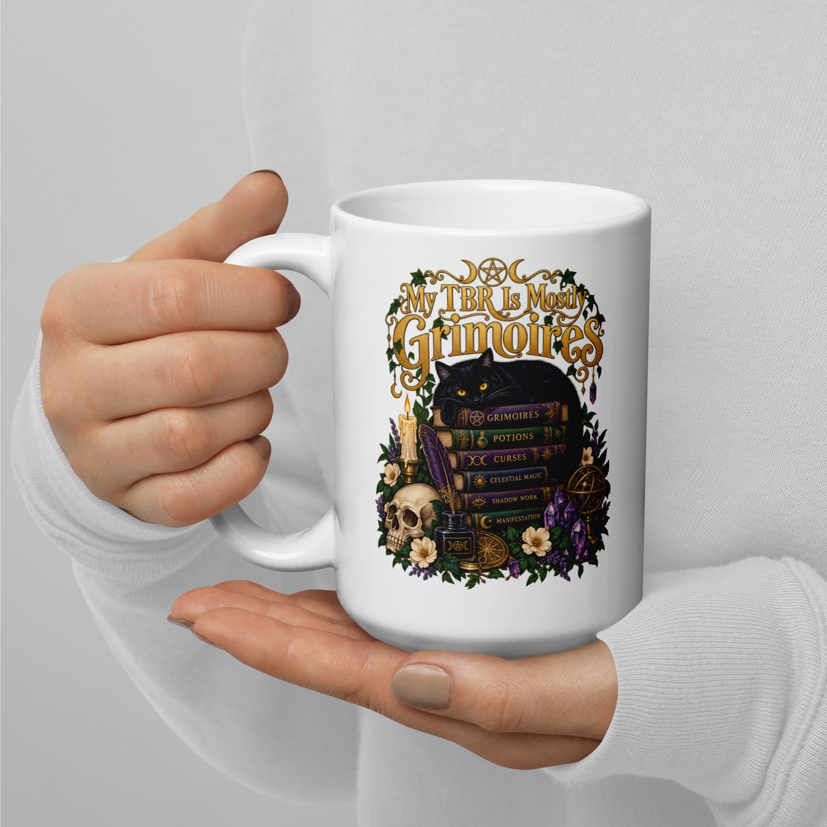 My TBR Is Mostly Grimoires dark academia design, a black cat guarding a stack of grimoires beside a skull, on a white glossy mug, 15 oz, handle on the left