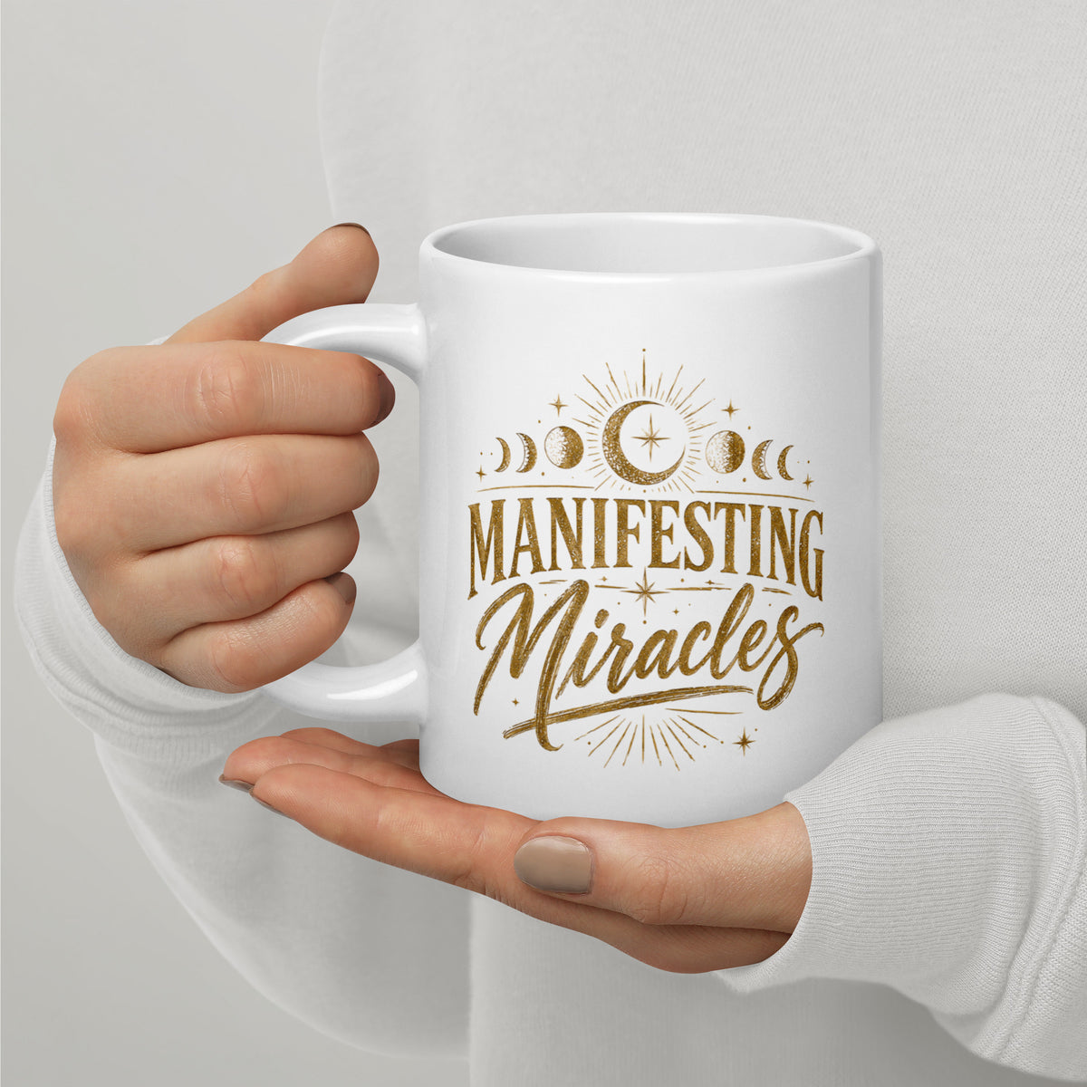 Manifesting Miracles design with moon phases in antique gold, on a white glossy mug, 20 oz, handle on the left