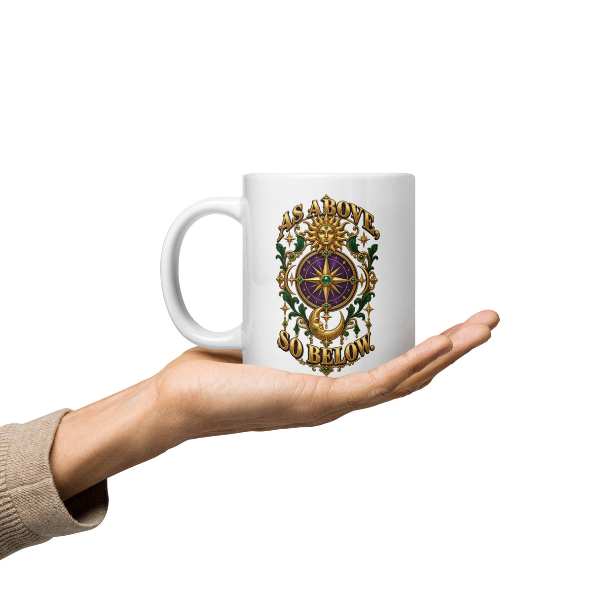 As Above, So Below astrology design, a gold sun face above a purple and gold compass rose with a crescent moon below, framed by emerald foliage, on a 20 oz white glossy mug, handle on the left