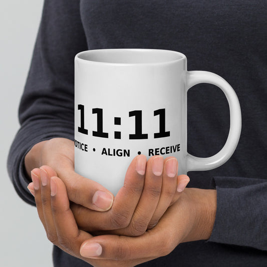 11:11 angel number design, the number set in plain white type above Notice, Align, Receive, on a white glossy mug, 20 oz, handle on the right