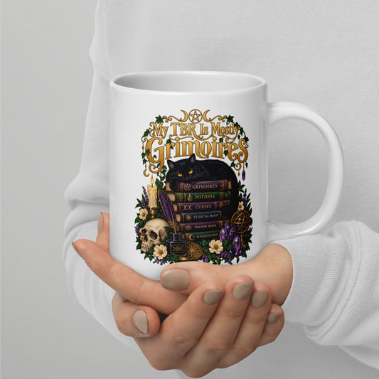 My TBR Is Mostly Grimoires dark academia design, a black cat guarding a stack of grimoires beside a skull, on a white glossy mug, 20 oz, handle on the right