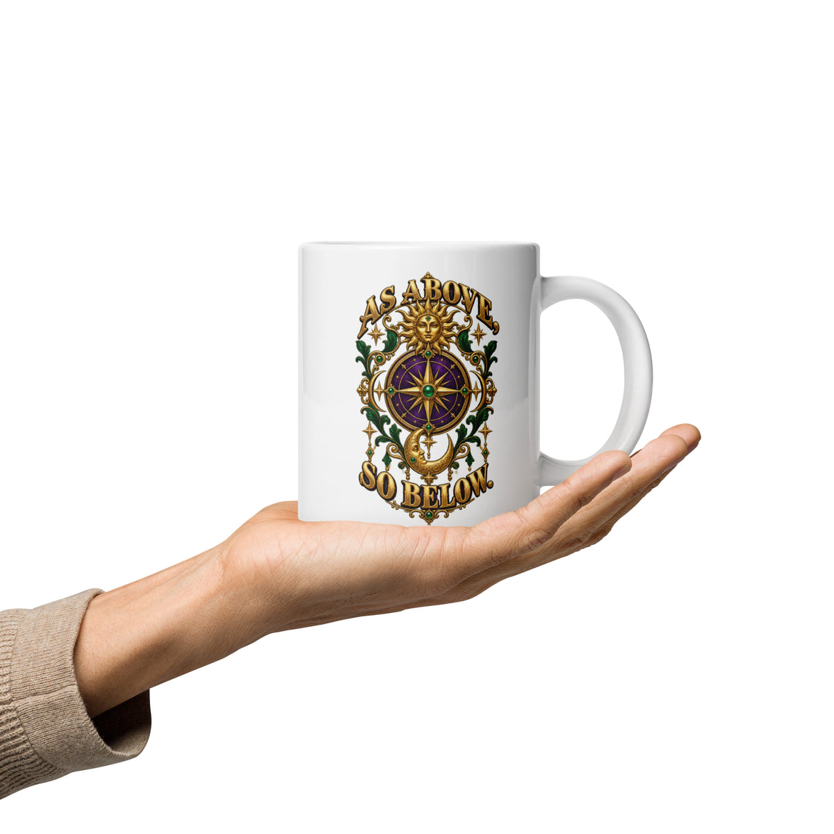 As Above, So Below astrology design, a gold sun face above a purple and gold compass rose with a crescent moon below, framed by emerald foliage, on a 20 oz white glossy mug, handle on the right