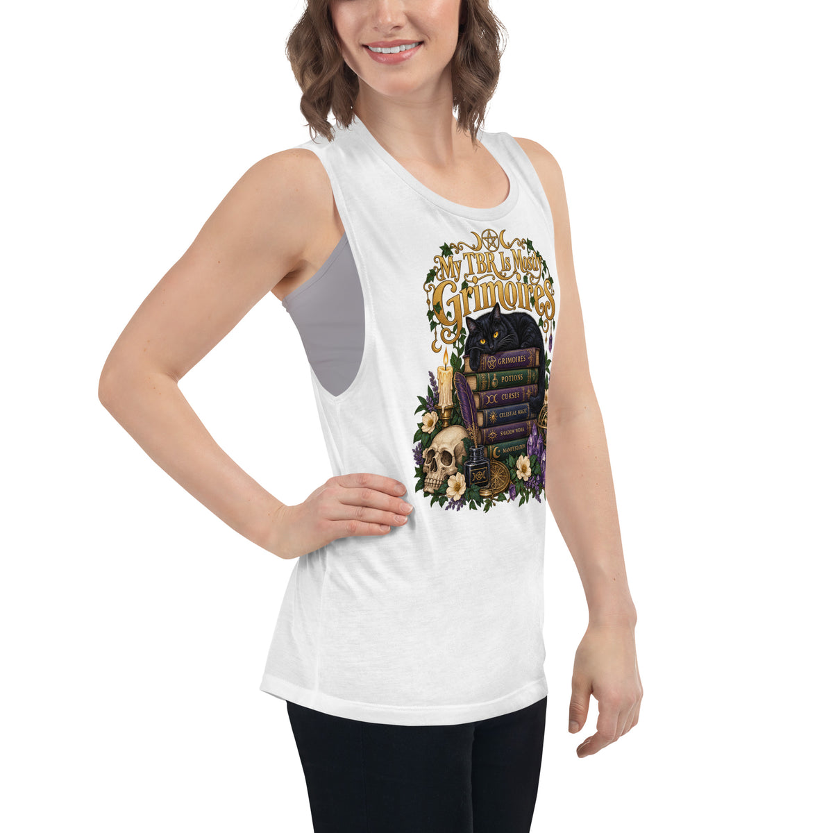 My TBR Is Mostly Grimoires dark academia design, a black cat guarding a stack of grimoires beside a skull, on a white ladies muscle tank, right front view