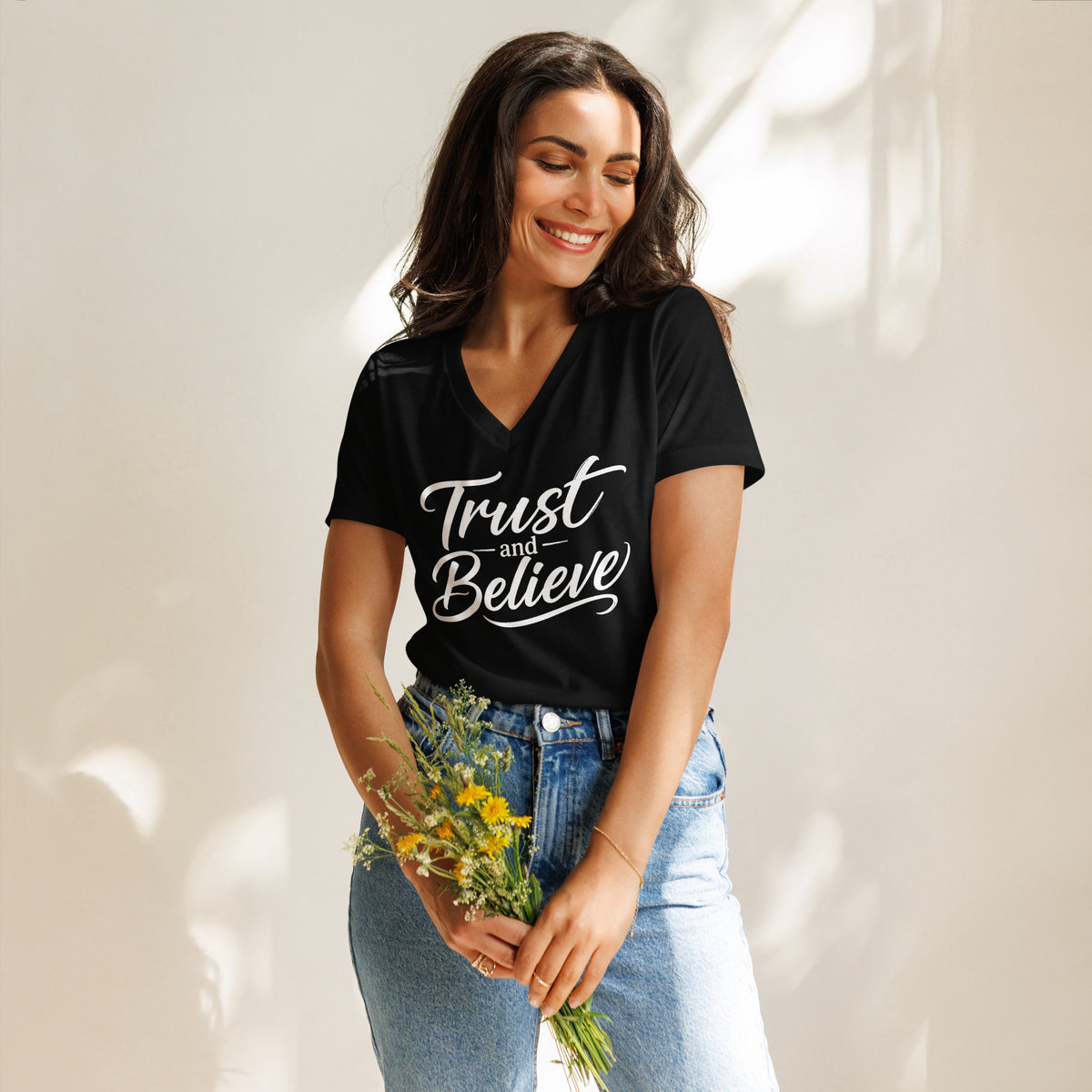 Trust and Believe design in white lettering, on a solid black blend women's relaxed v-neck t-shirt, front view
